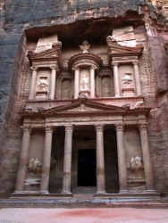 Tourists walking through the narrow Siq canyon